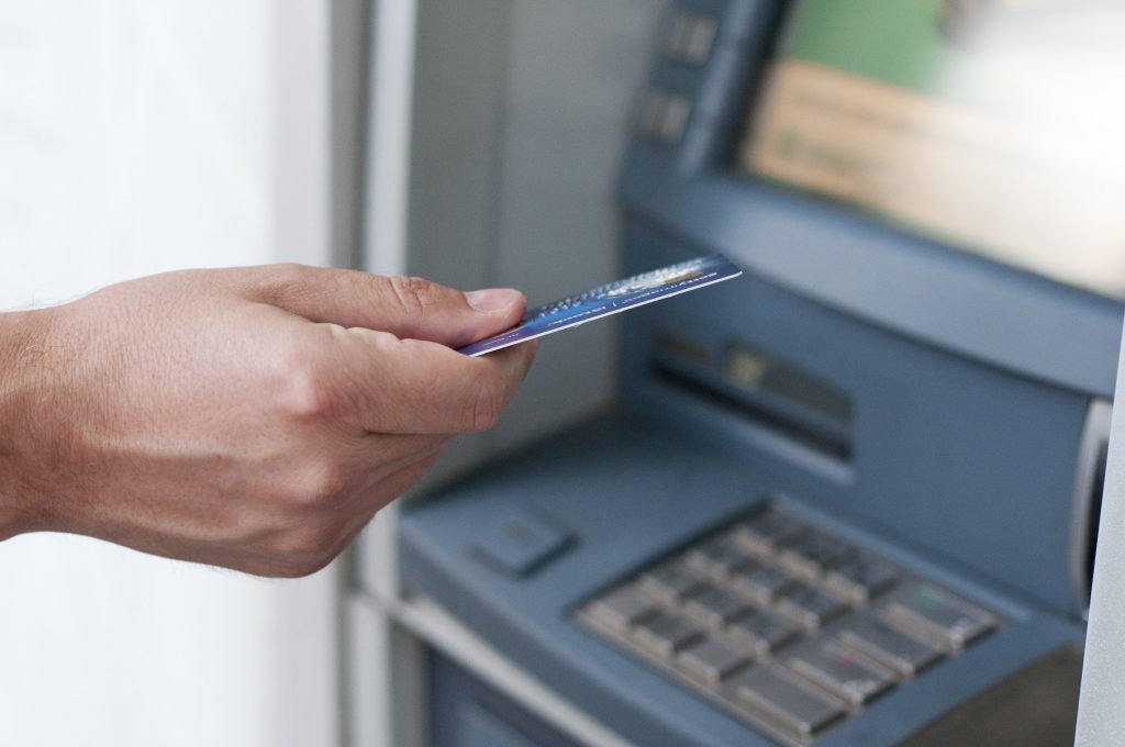 hand-inserting-atm-card-into-bank-machine-withdraw-money-businessman-men-hand-puts-credit-card-into-atm-1-min-1024x680-1